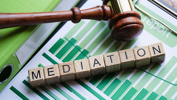 Image of gavel and word "Mediation" in blocks contract dispute issue