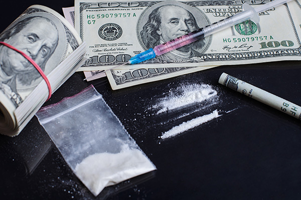Image of drug crimes money and cocaine on a table