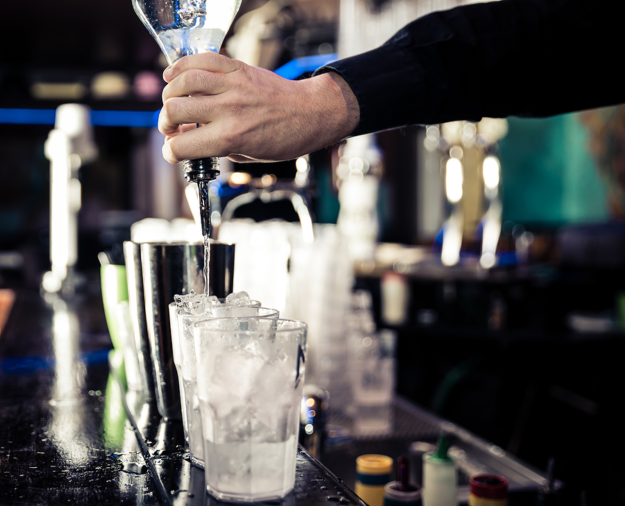 bartender pouring alcohol drinks in a bar